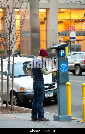 Young man paying parking permit on street in New York city 2010 Stock Photo