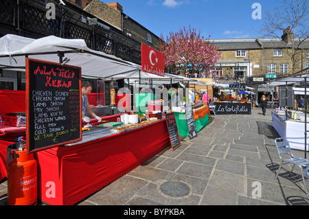 Turkish kebab street food stall business at colourful spring outdoor market Camden London England UK Stock Photo