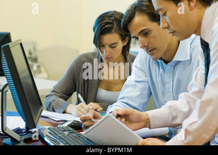 Executives working on project together Stock Photo