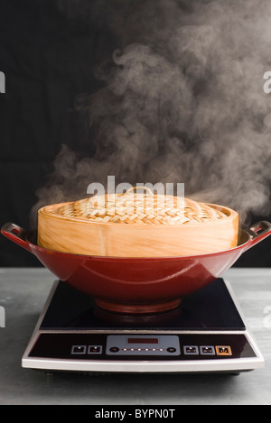 Cooking with steamer basket Stock Photo