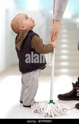 Little child asking mom to let him help her Stock Photo