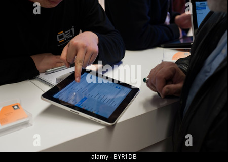 Paris, France, Business Electronics Trade Show, Salesman showing , Apple Ipad Tablet Computer to customer, people working on MAC Stock Photo