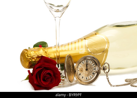 wet red rose under a champagne bottle with a old pocket watch and a empty champagne glass on white background Stock Photo