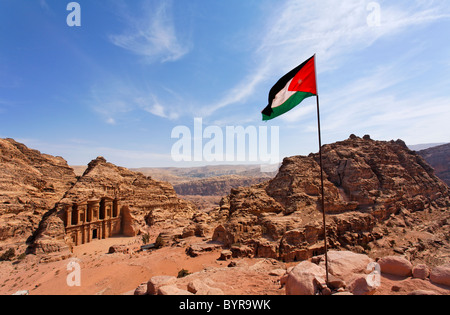 Jordanian flag flying in front of the Monastery, sculpted out of the rock, at Petra, Jordan Stock Photo