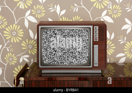retro wooden tv on wooden vitage 60s furniture floral wallpaper Stock Photo