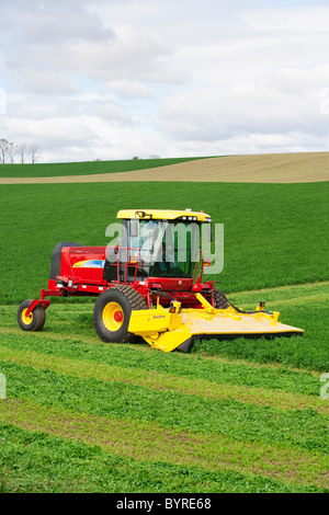 Agriculture - A self propelled New Holland Discmower silage harvester cuts and windrows alfalfa / near Madison, Wisconsin, USA. Stock Photo
