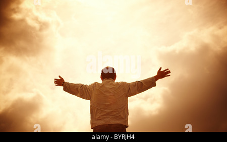 man and dramatic clouds, special toned photo f/x, selective focus on head Stock Photo