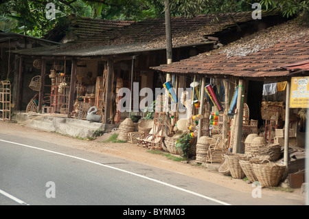 Sri Lanka. Typical views along Route A1 between Colombo and Kandy. Roadside vendor selling local rattan (aka wicker) goods. Stock Photo