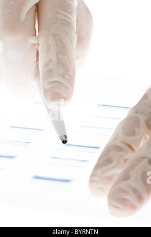 Researcher examining DNA sequence transparency slide Stock Photo