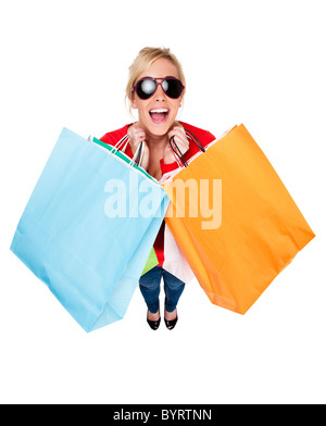 Attractive young woman wearing sunglasses looking happing holding multi-coloured shopping bags Stock Photo