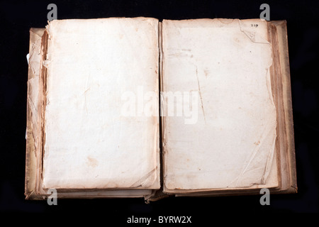 ancient book, almost 300 years, opened on two blank sheets isolated on black Stock Photo