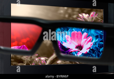 Glasses 3D in front of the TV with a flower. 3D television. Stock Photo