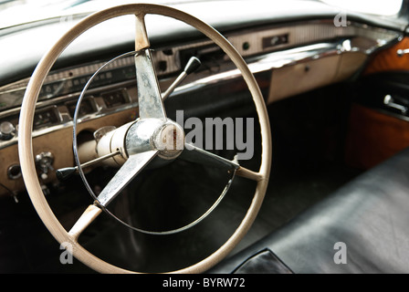 Interior of a vintage car with the steering wheel on the foreground. Holguin, Cuba, Caribbean. Stock Photo