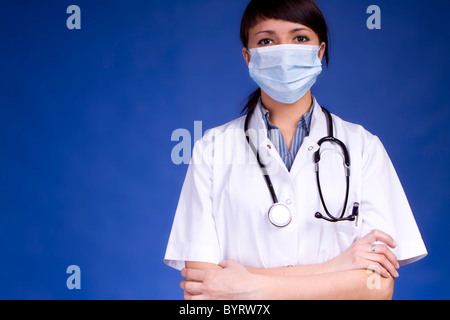 Woman Doctor Wearing A Mask Examining You Stock Photo