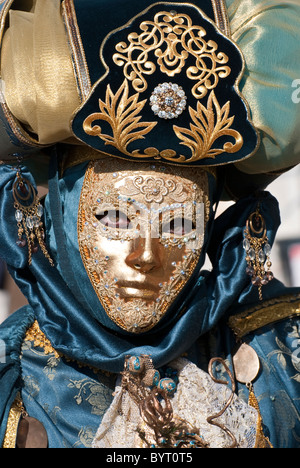 Close-up of venetian mask during carnival. Posing near a street lamp ...