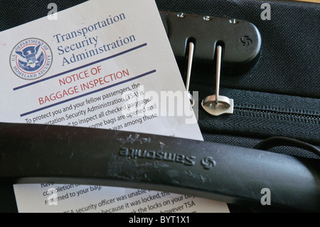 TSA Notice of Baggage Inspection with an open lock on a suitcase Stock ...