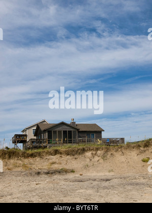 Beach front home in Nags Head on North Carolinas Outer Banks. The house sits on a dune with a beautiful cloudscape above Stock Photo