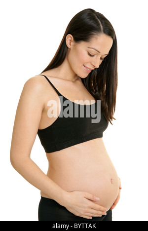 Pregnant woman looking at her growing bump Stock Photo