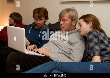Family using laptop computer Stock Photo