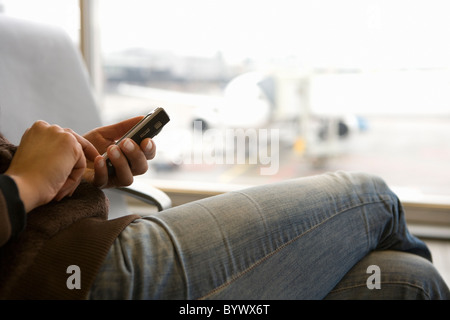 Woman using smart phone body cropped Stock Photo