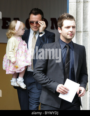 Shane Filan and daughter Nicole with Mark Feehily at the christening of Nicky Byrne of Westlife and his wife Georgina twin Stock Photo