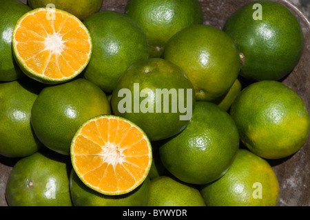 Oranges in a cup, one is open Stock Photo