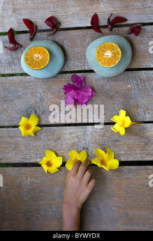 Face made with stones and flowers Stock Photo