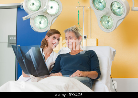 Nurse and patient looking at xray Stock Photo