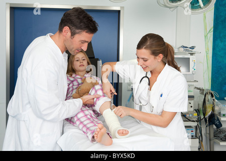 Doctor and nurse cut opening plaster Stock Photo
