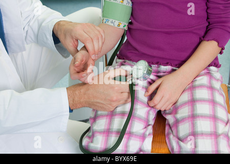 Doctor testing childs blood pressure Stock Photo