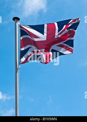 Union jack flag fluttering in the breeze with blue sky background in ...