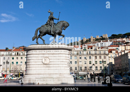 Figueira Square in the Baixa district in Lisbon , Portugal. King Dom Joao I statue with the Sao Jorge Castle on top of hill. Stock Photo