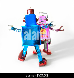 Dancing toy robots, male and female likeness. Stock Photo