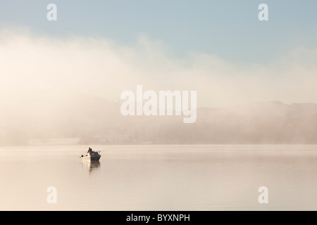 Char fishermen on Lake Windermere on a misty winters morning, Lake District, UK. Stock Photo