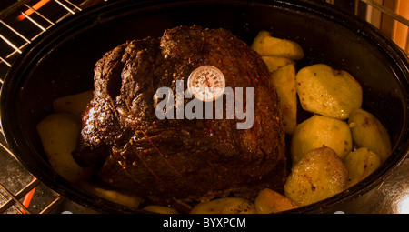 Roast beef in oven with thermometer Stock Photo