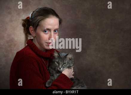 young girl 18-20 years old holding a domestic cat Stock Photo