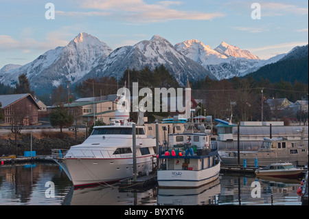 Crescent harbor and snow capped mountains during a winter sunrise in Sitka, Alaska. Stock Photo