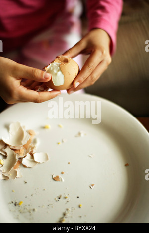 Girl eats hard boiled eggs. Stock Photo