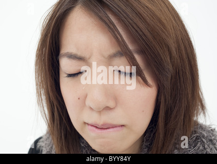 Young woman shedding tears Stock Photo