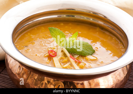 Lentil soup in a brass bowl as closeup Stock Photo