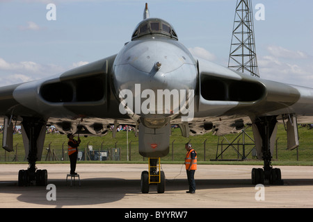 Vulcan bomber on the runway after having landed at RAF Lyneham, ground crew preparing aircraft for static display Stock Photo