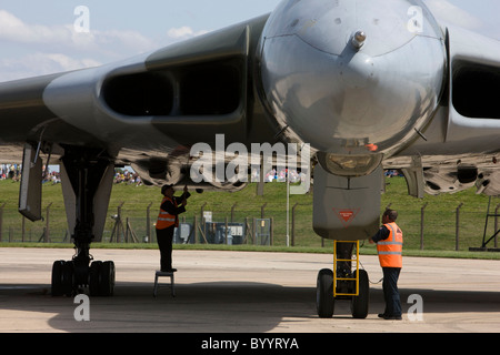 Vulcan bomber on the runway after having landed at RAF Lyneham, ground crew preparing aircraft for static display Stock Photo