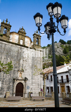 Buildings and church building in typical / traditional street / road scene in Grazalema, White Village in Andalusia, Spain Stock Photo