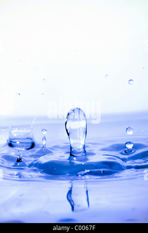 Blue splashing water droplets background. Shallow depth of field. Stock Photo