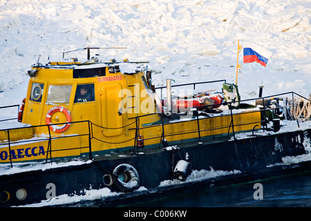 Ice breaker on frozen Neva river with Peter and Paul Fortress in background, St Petersburg Russia Stock Photo