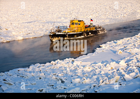 Ice breaker on frozen Neva river with Peter and Paul Fortress in background, St Petersburg Russia Stock Photo