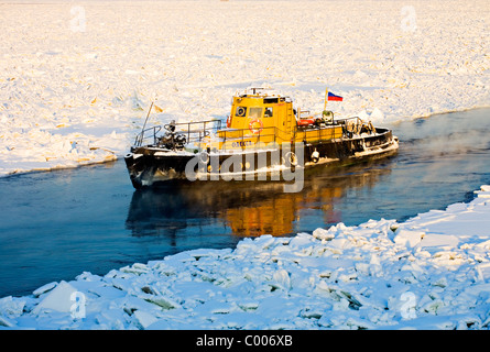 Ice breaker on frozen Neva river with Peter and Paul Fortress in background, St Petersburg Russia Stock Photo