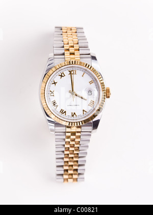 Expensive gold bevelled watch with white face and gold hands and numerals against white background Stock Photo