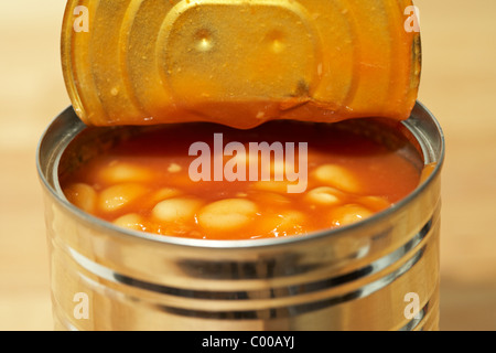 tin can of baked beans in tomato sauce opened with lid peeled back Stock Photo