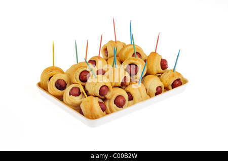 Pigs in a Blanket with toothpicks on serving tray on white background, cutout. Stock Photo